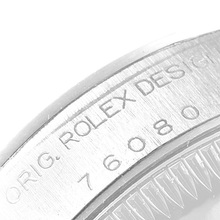 This image shows a close-up of the side engraving on a Rolex Oyster Perpetual 76080 Women's Stainless Steel Black Dial 76080 Women's Stainless Steel Black Dial watch bezel.