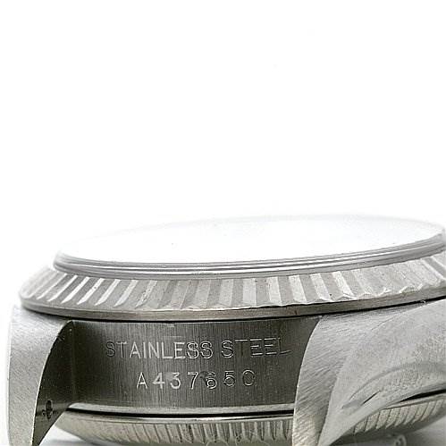 This image shows a close-up side view of the casing and bezel of a Rolex Oyster Perpetual 76094 Women's Stainless Steel Black Dial 76094 Women's Stainless Steel Black Dial watch, including the engraved serial number.