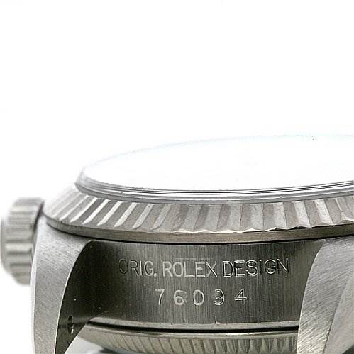 This image shows a side angle of the case and crown of a Rolex Oyster Perpetual 76094 Women's Stainless Steel Black Dial 76094 Women's Stainless Steel Black Dial watch, displaying the original design engraving and model number.