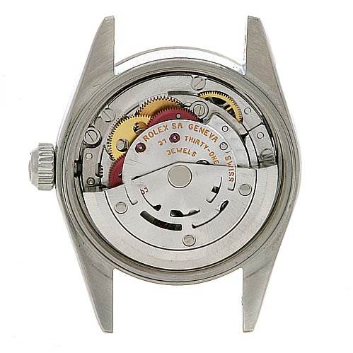 This image shows the back view of a Rolex Oyster Perpetual 76094 Women's Stainless Steel Black Dial 76094 Women's Stainless Steel Black Dial watch, revealing its internal mechanical movement.