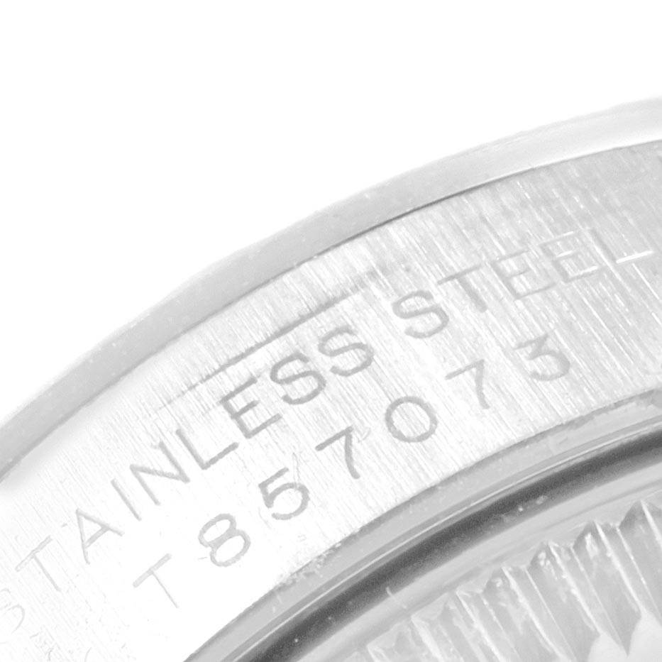 The image shows a close-up angle of the Rolex Oyster Perpetual 67230 Women's Stainless Steel White Dial 67230 Women's Stainless Steel White Dial model, highlighting the stainless steel caseback with part of its engraved serial number.