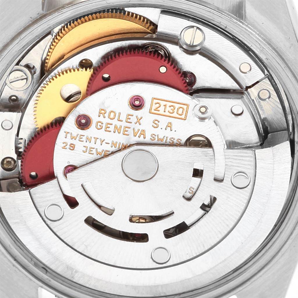 This image shows the internal movement components of the Rolex Oyster Perpetual 67230 Women's Stainless Steel White Dial 67230 Women's Stainless Steel White Dial watch, including gears and the rotor.