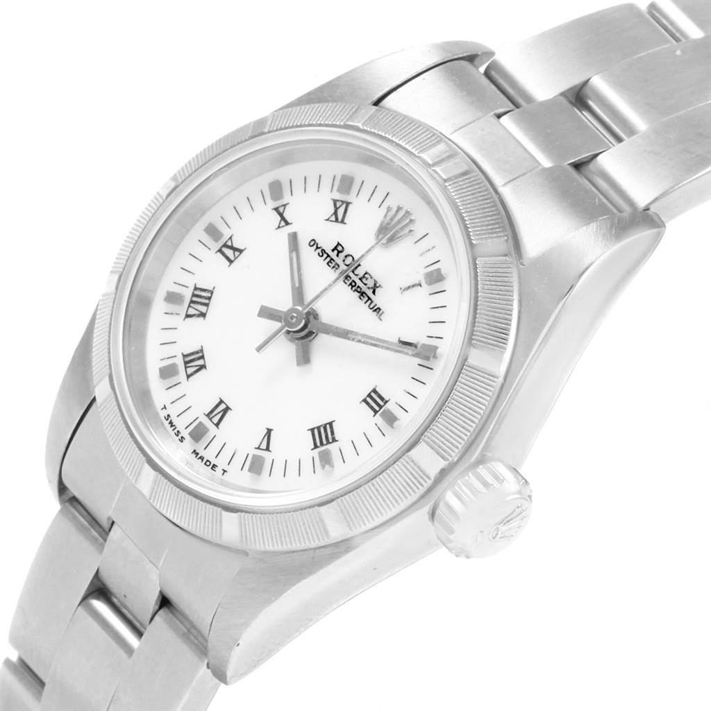 This image shows a Rolex Oyster Perpetual 67230 Women's Stainless Steel White Dial 67230 Women's Stainless Steel White Dial watch from a top-side angle, highlighting the face, bezel, and a portion of the bracelet.