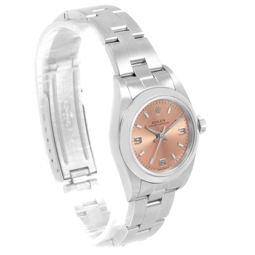 The image shows a Rolex Oyster Perpetual 76080 Women
s Stainless Steel Pink Dial 76080 Women
s Stainless Steel Pink Dial watch, displaying the watch face, bezel, crown, and part of the bracelet from an angled side view.