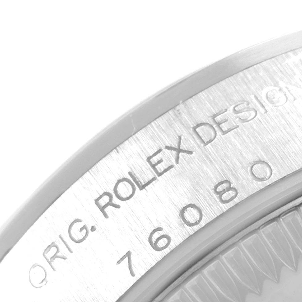 The image shows a close-up of the case back engraving on a Rolex Oyster Perpetual 76080 Women
s Stainless Steel Pink Dial 76080 Women
s Stainless Steel Pink Dial watch, displaying part of the model number and "ORIG. ROLEX DESIGN."