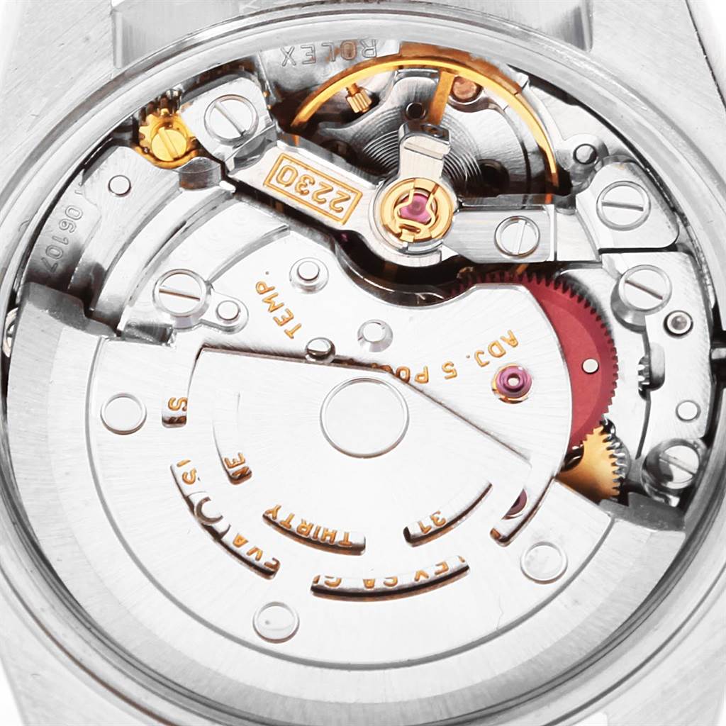The image shows the intricate internal movement of a Rolex Oyster Perpetual 76080 Women
s Stainless Steel Pink Dial 76080 Women
s Stainless Steel Pink Dial watch from a close-up angle.