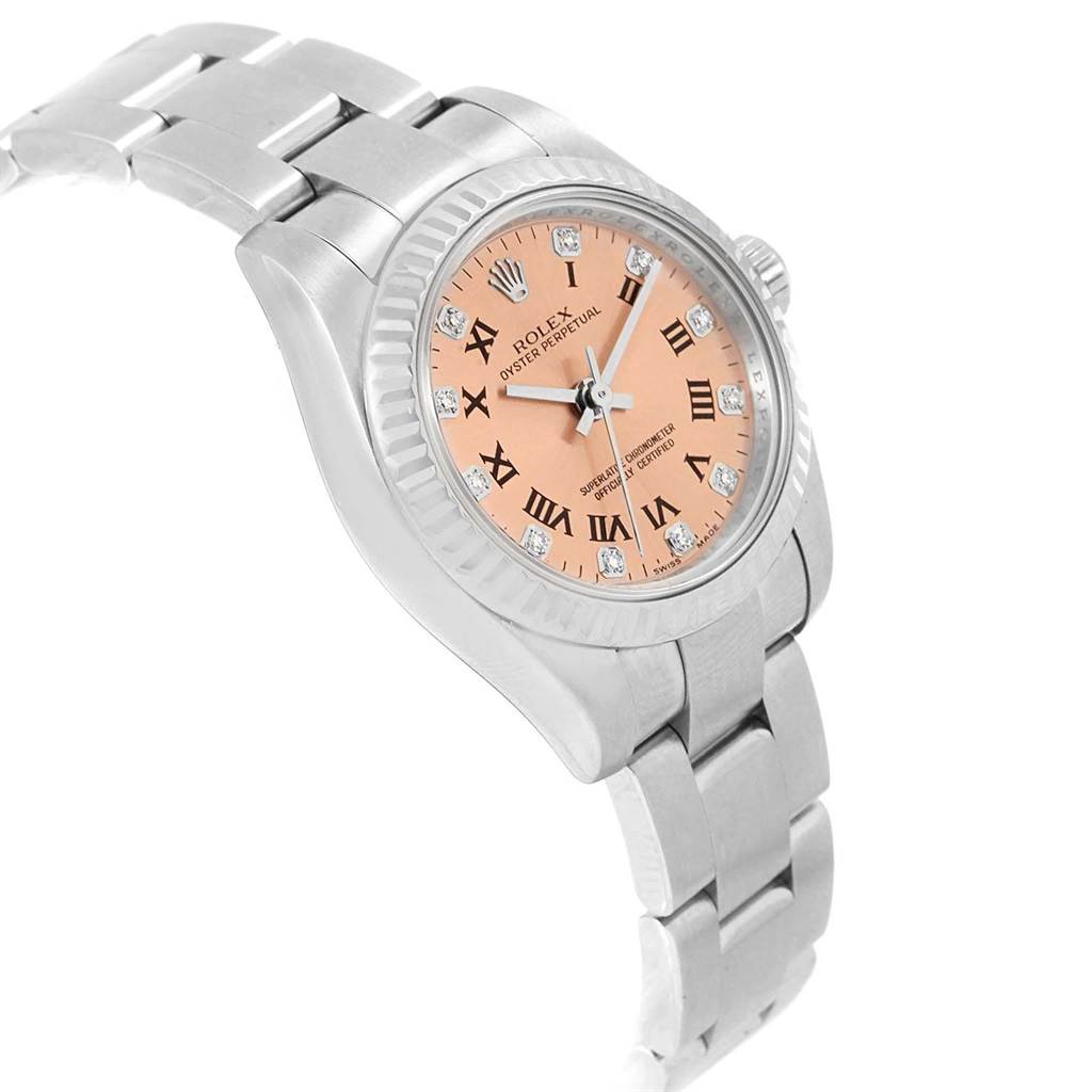 The Rolex Oyster Perpetual 176234 Women
s Stainless Steel Pink Dial 176234 Women
s Stainless Steel Pink Dial watch is shown at a tilted angle, displaying its salmon-colored dial, Roman numerals, and stainless steel bracelet.