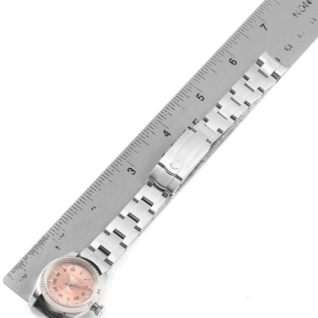 The image shows a Rolex Oyster Perpetual 176234 Women
s Stainless Steel Pink Dial 176234 Women
s Stainless Steel Pink Dial watch with a metal bracelet and clasp, placed next to a ruler for size reference.