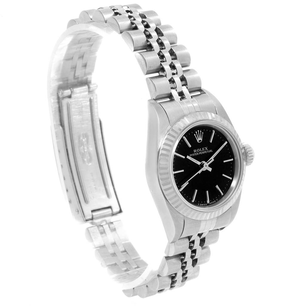 The image shows a Rolex Oyster Perpetual 67194 Women
s Stainless Steel Black Dial 67194 Women
s Stainless Steel Black Dial watch angled slightly to the right, highlighting the black dial, metal bracelet, and clasp.
