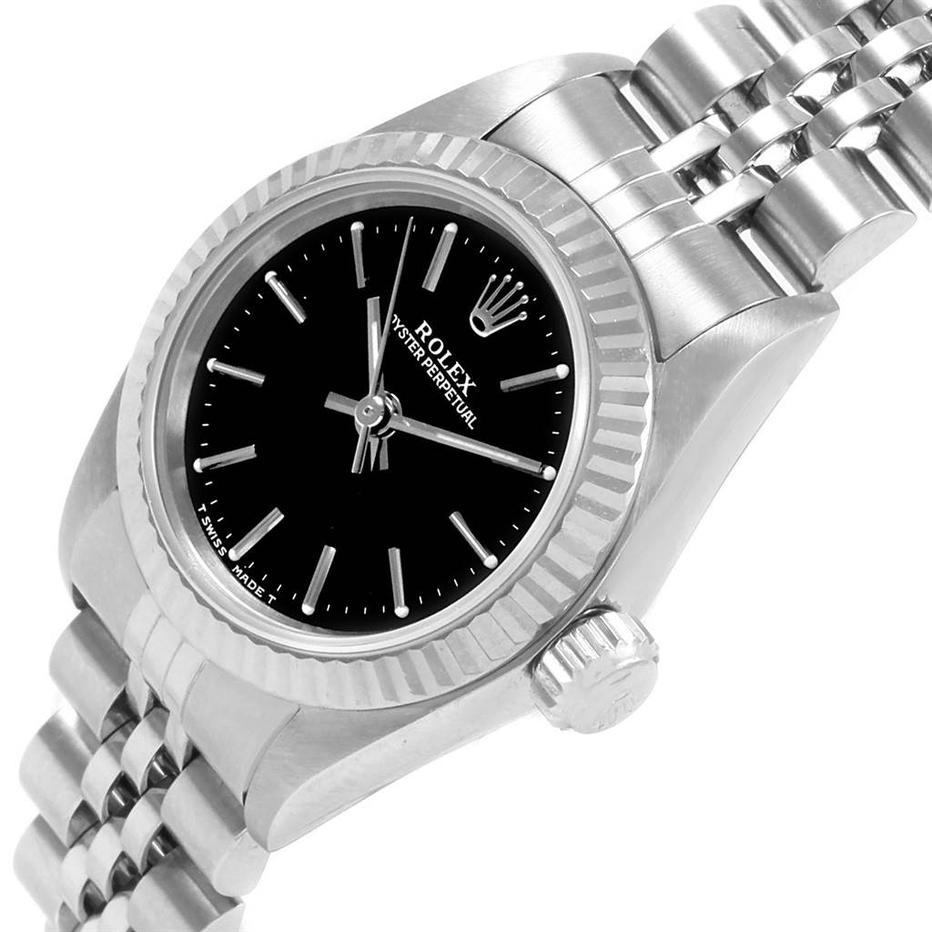 The image shows a Rolex Oyster Perpetual 67194 Women
s Stainless Steel Black Dial 67194 Women
s Stainless Steel Black Dial watch from an oblique angle, focusing on the dial, bezel, crown, and part of the bracelet.