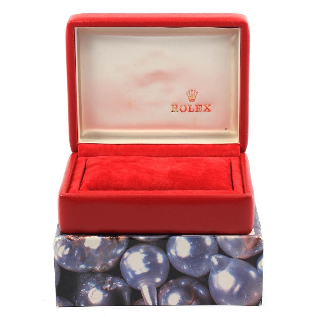 This image shows a red Rolex Oyster Perpetual 67194 Women
s Stainless Steel Black Dial 67194 Women
s Stainless Steel Black Dial watch box, open, without the watch inside.