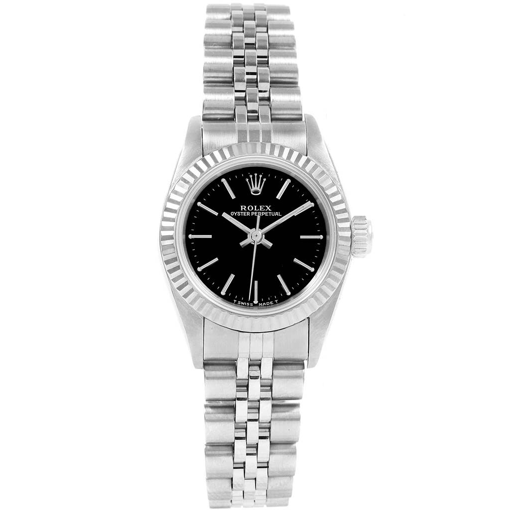 The image shows a front view of a Rolex Oyster Perpetual 67194 Women
s Stainless Steel Black Dial 67194 Women
s Stainless Steel Black Dial watch, highlighting the black dial, fluted bezel, and silver bracelet.