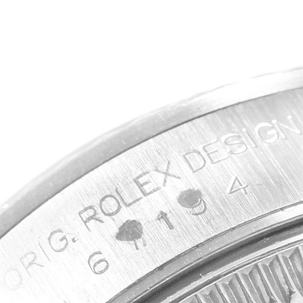 The image shows a close-up of the side of a Rolex Oyster Perpetual 67194 Women
s Stainless Steel Black Dial 67194 Women
s Stainless Steel Black Dial watch, highlighting the engraved text.