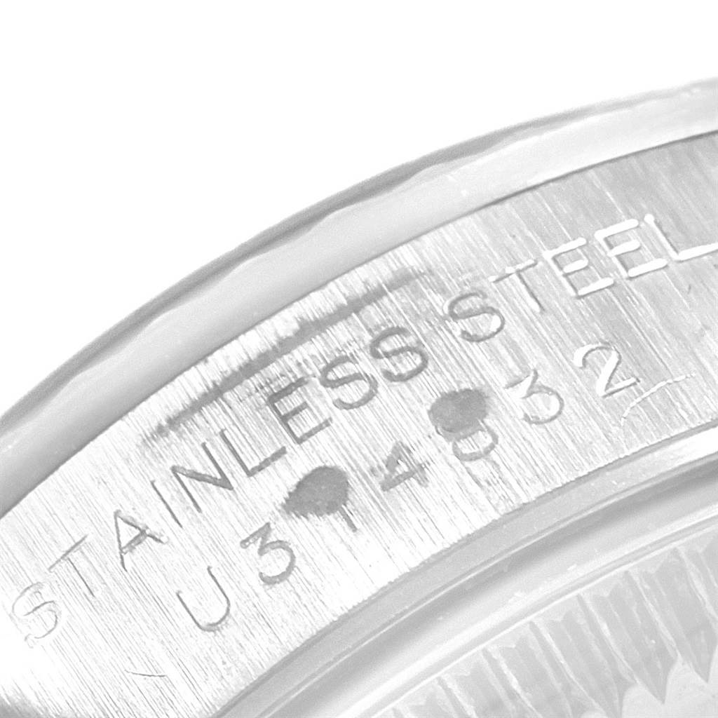 The image shows a close-up of the back casing of the Rolex Oyster Perpetual 67194 Women
s Stainless Steel Black Dial 67194 Women
s Stainless Steel Black Dial watch, highlighting the stainless steel markings.