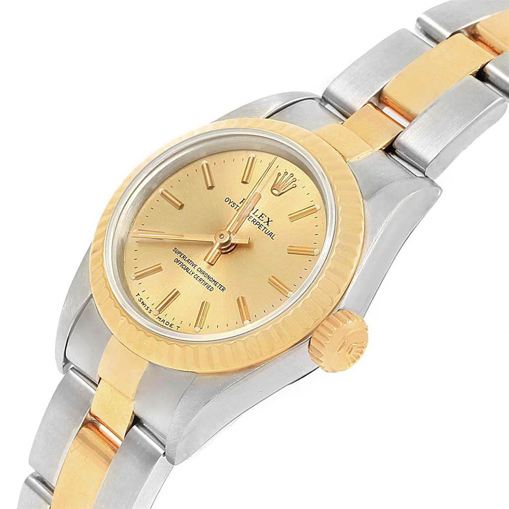 The image shows a Rolex Oyster Perpetual 67193 Women
s Steel and Gold (two tone) Champagne Dial 67193 Women
s Steel and Gold (two tone) Champagne Dial watch at an angle, displaying the gold dial, bezel, and two-tone bracelet.