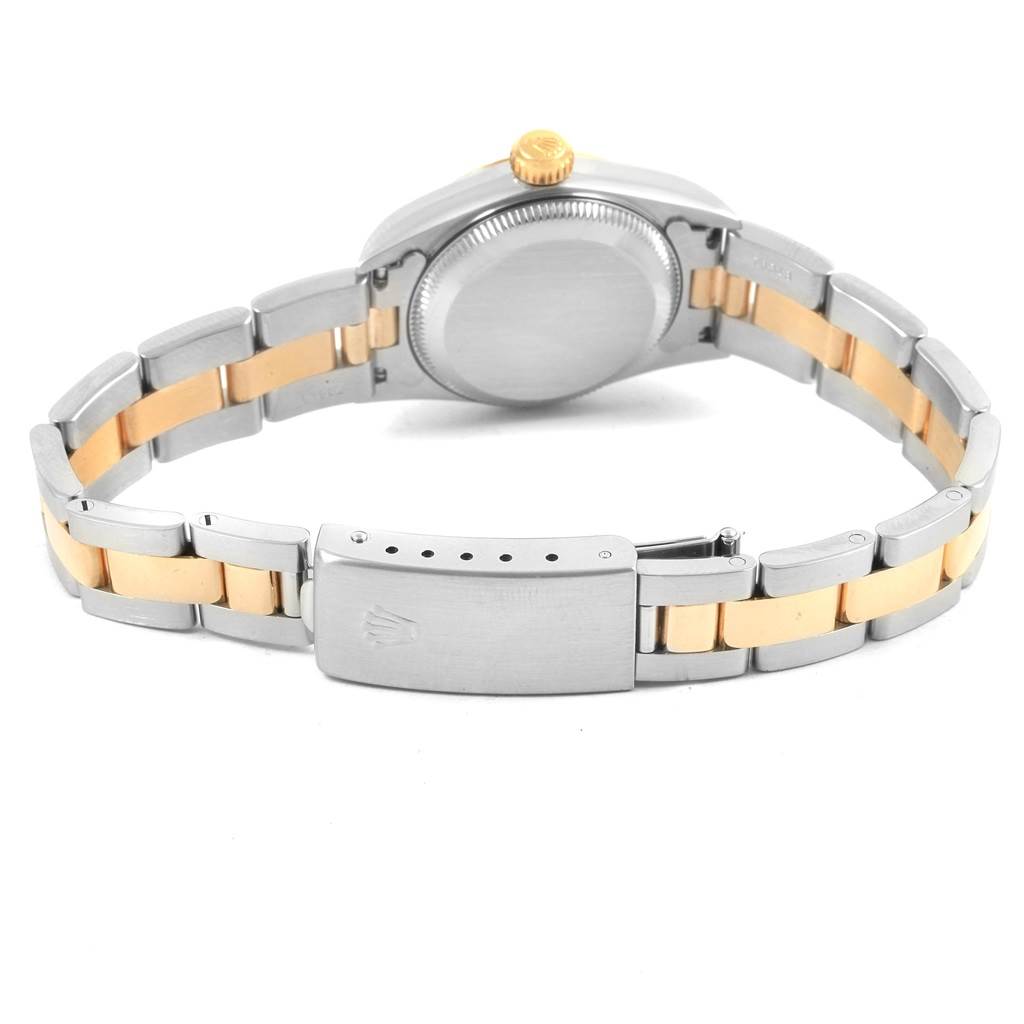 This Rolex Oyster Perpetual 67193 Women
s Steel and Gold (two tone) Champagne Dial 67193 Women
s Steel and Gold (two tone) Champagne Dial watch is shown from the back, highlighting the clasp, bracelet, and case back.