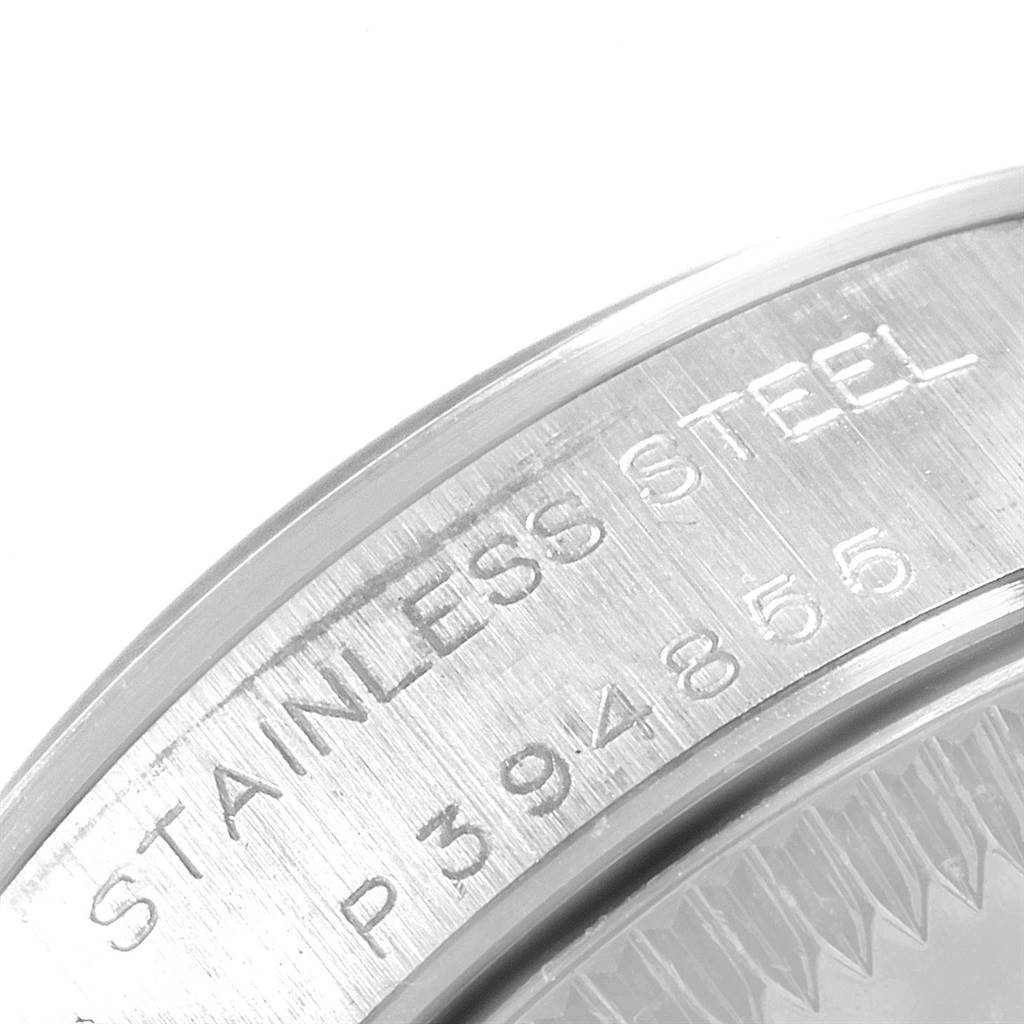 This close-up image shows the stainless steel case back of a Rolex Oyster Perpetual 76080 Women
s Stainless Steel Black Dial 76080 Women
s Stainless Steel Black Dial watch with engraved serial numbers.