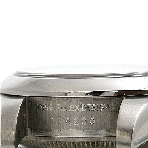 This image shows a close-up side view of the case and bezel of a Rolex Oyster Perpetual 0176200SAPSO Women's Stainless Steel Silver Dial 0176200SAPSO Women's Stainless Steel Silver Dial watch, featuring the engraved design serial number.