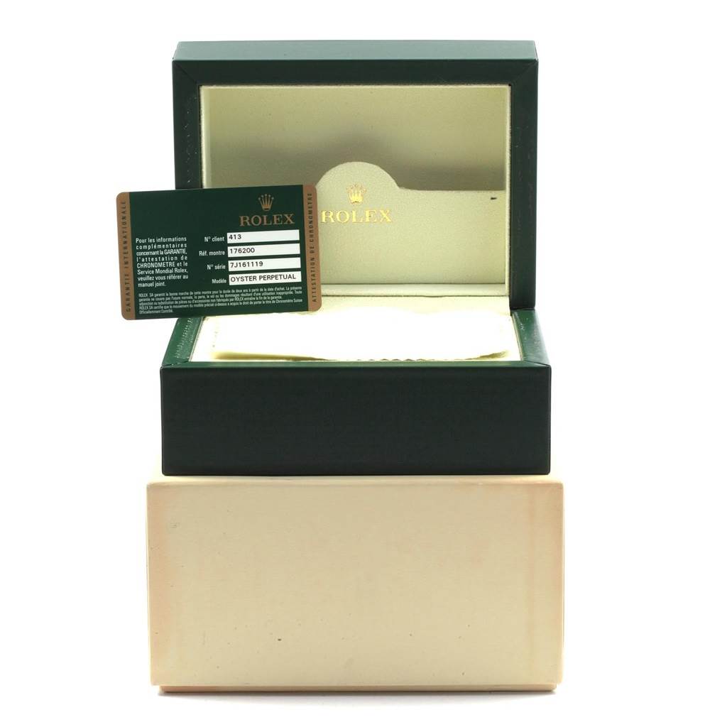 The image displays an open Rolex Oyster Perpetual 176200 Women
s Stainless Steel Silver Dial 176200 Women
s Stainless Steel Silver Dial watch box and an Best Quality
ity card placed in front of it.