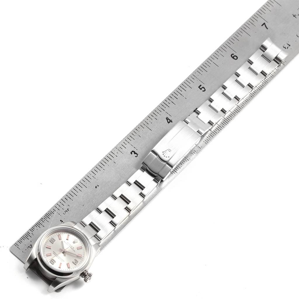 The image shows a top-down view of a Rolex Oyster Perpetual 176200 Women
s Stainless Steel Silver Dial 176200 Women
s Stainless Steel Silver Dial watch, including the face, bracelet, and clasp beside a ruler.