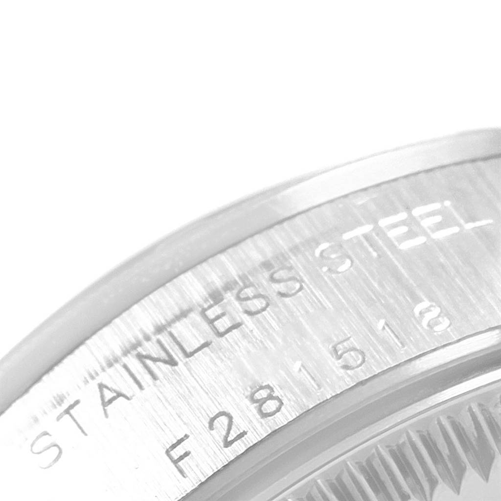 The image shows a close-up of the engraved stainless steel case back of a Rolex Oyster Perpetual 76030 Women
s Stainless Steel Black Dial 76030 Women
s Stainless Steel Black Dial watch.