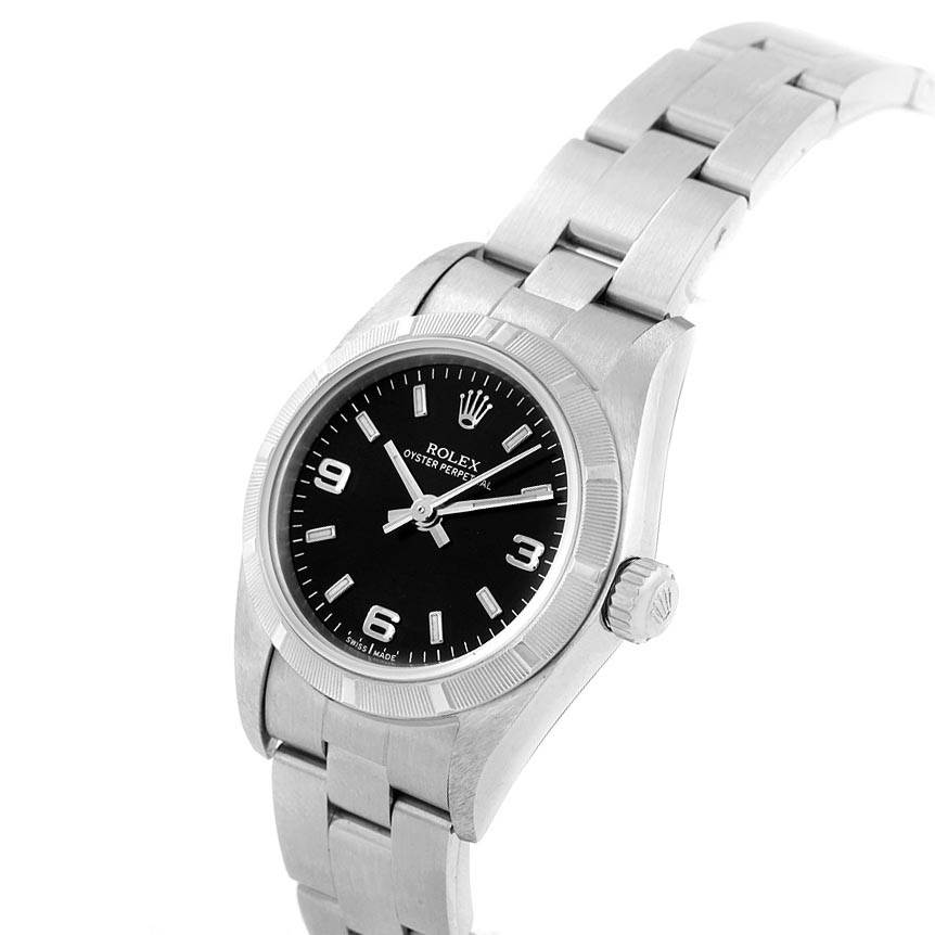 The image shows a Rolex Oyster Perpetual 76030 Women
s Stainless Steel Black Dial 76030 Women
s Stainless Steel Black Dial watch angled from the top-left, highlighting the dial, bezel, and part of the bracelet.