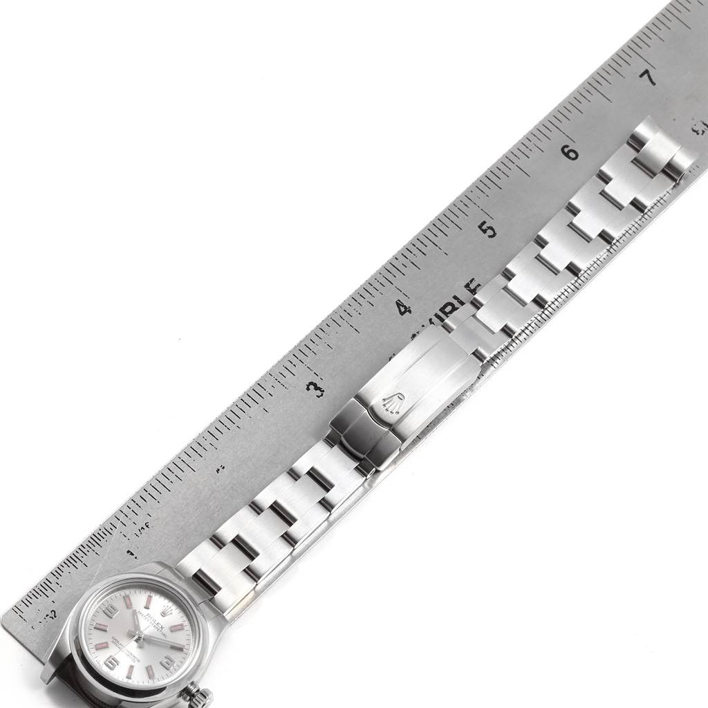 The image shows a partial side view of a Rolex Oyster Perpetual 176200 Women
s Stainless Steel Silver Dial 176200 Women
s Stainless Steel Silver Dial watch, including its face, band, and clasp measured against a ruler.