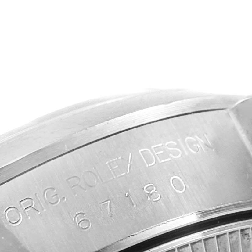 The image shows an engraved close-up of the case back of the Rolex Oyster Perpetual 67180 Women
s Stainless Steel Silver Dial 67180 Women
s Stainless Steel Silver Dial watch.