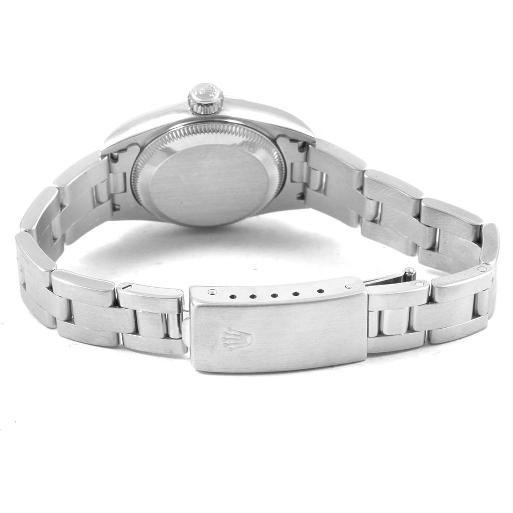 The image shows the back view of a Rolex Oyster Perpetual 67180 Women
s Stainless Steel Silver Dial 67180 Women
s Stainless Steel Silver Dial watch, highlighting its case back, crown, and bracelet clasp.