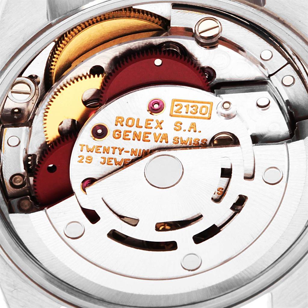 The image shows the movement mechanism of a Rolex Oyster Perpetual 67180 Women
s Stainless Steel Silver Dial 67180 Women
s Stainless Steel Silver Dial watch, highlighting the intricate parts like gears and jewels.