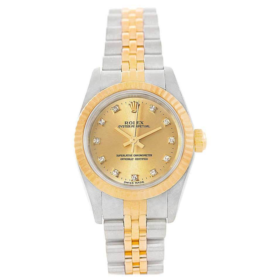 This image shows a Rolex Oyster Perpetual 76193 Women
s Steel and Gold (two tone) Champagne Dial 76193 Women
s Steel and Gold (two tone) Champagne Dial watch from a top view, highlighting its yellow gold and stainless steel bracelet and diamond-set dial.