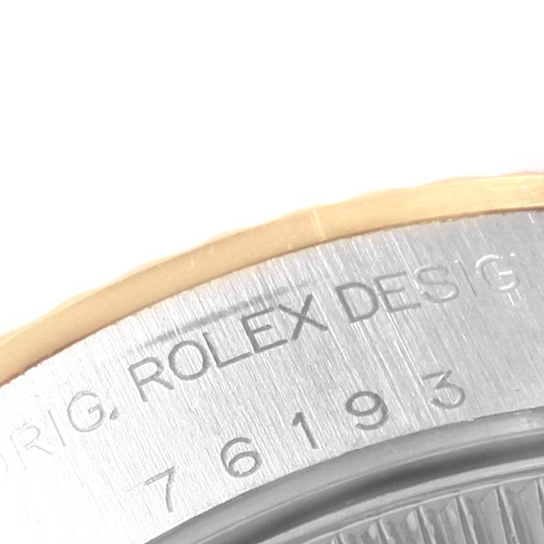 This image shows a close-up of the bezel and engraved part of the case back of a Rolex Oyster Perpetual 76193 Women
s Steel and Gold (two tone) Champagne Dial 76193 Women
s Steel and Gold (two tone) Champagne Dial watch, highlighting the branding.