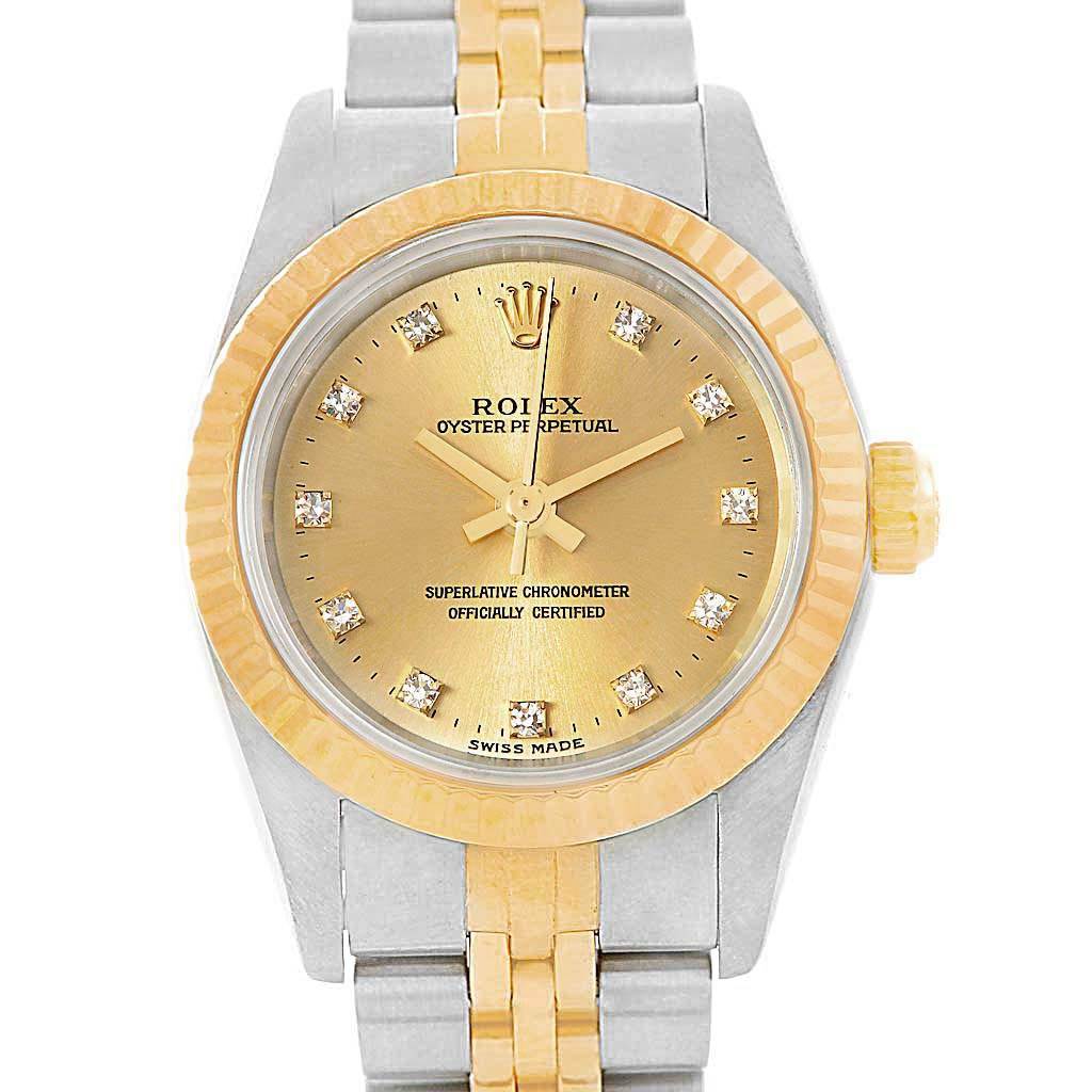 The image shows a front view of a Rolex Oyster Perpetual 76193 Women
s Steel and Gold (two tone) Champagne Dial 76193 Women
s Steel and Gold (two tone) Champagne Dial watch, highlighting its gold dial, bezel, and bi-metal bracelet.