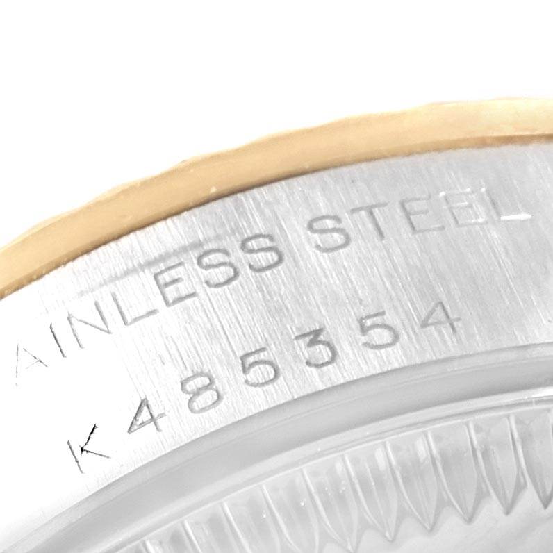 This image shows a close-up of the serial number and stainless steel engravings on the case back of a Rolex Oyster Perpetual 76193 Women
s Steel and Gold (two tone) Champagne Dial 76193 Women
s Steel and Gold (two tone) Champagne Dial watch.