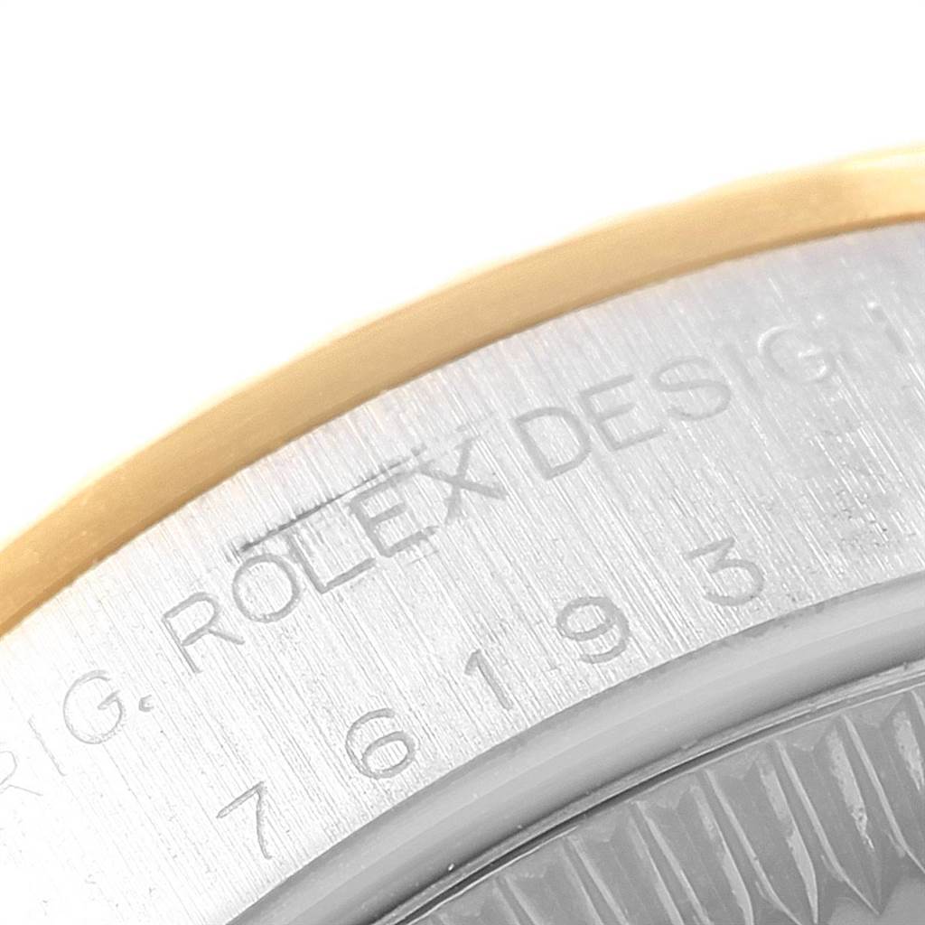 The image shows a close-up of the engraved bezel and case of the Rolex Oyster Perpetual 76193 Women's Steel and Gold (two tone) White Dial 76193 Women's Steel and Gold (two tone) White Dial watch.