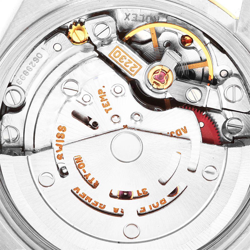 This image shows the detailed inner mechanism of a Rolex Oyster Perpetual 76193 Women's Steel and Gold (two tone) White Dial 76193 Women's Steel and Gold (two tone) White Dial watch, including gears, screws, and inscriptions.