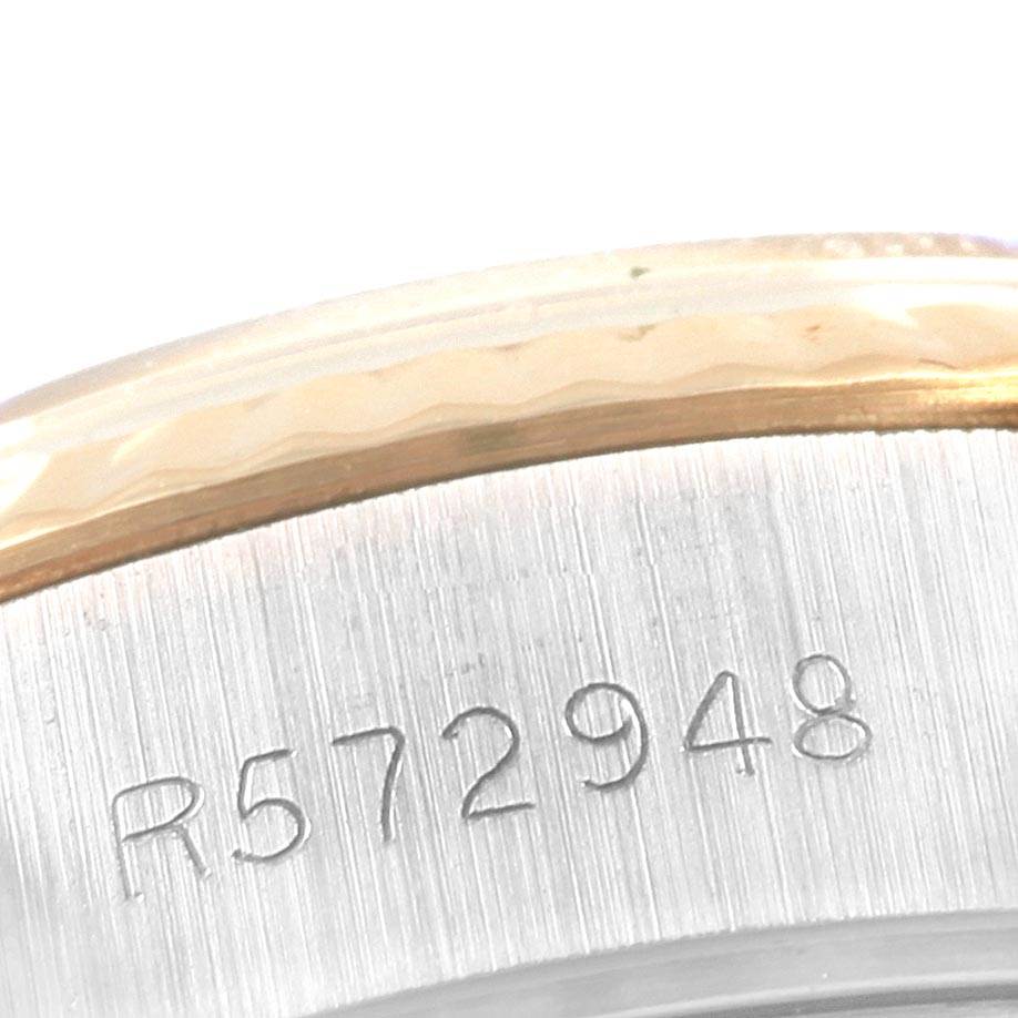 This is a close-up of the case edge and serial number engraving on a Rolex Oyster Perpetual 69173 Women's Stainless Steel Champagne Dial 69173 Women's Stainless Steel Champagne Dial watch.