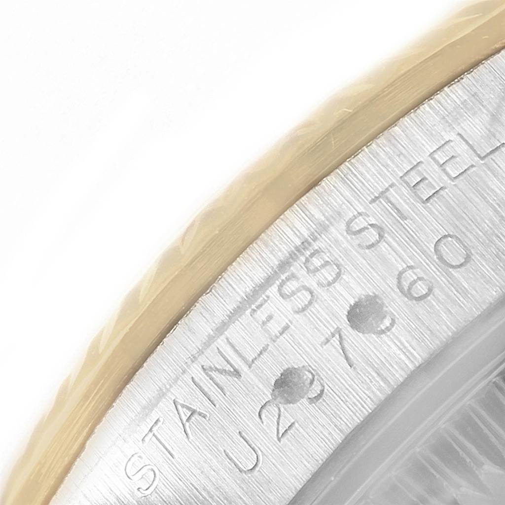 This close-up image shows part of the stainless steel casing of a Rolex Oyster Perpetual 67193 Women's Steel and Gold (two tone) White Dial 67193 Women's Steel and Gold (two tone) White Dial watch.