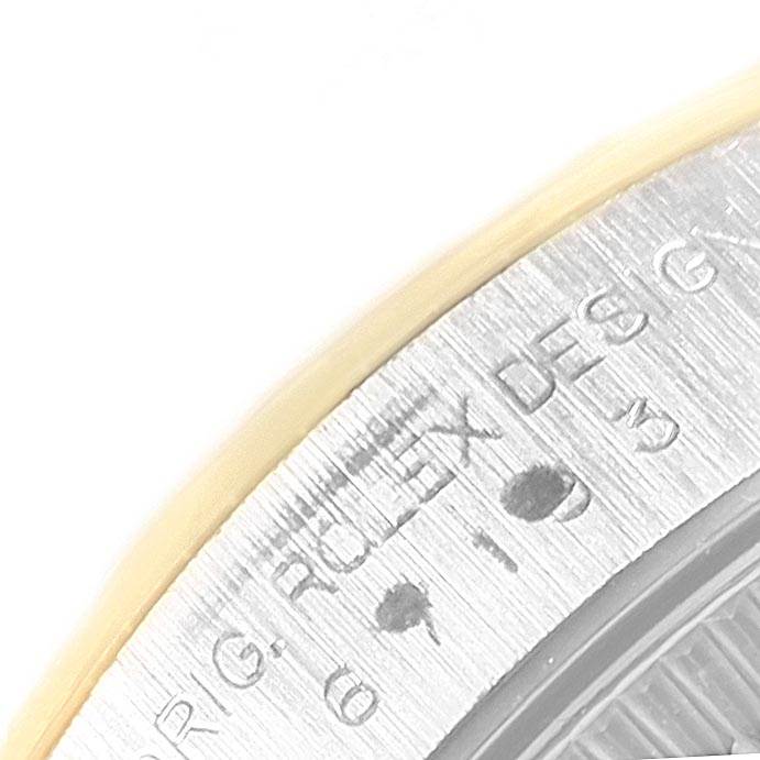 The image shows a close-up angle of the engraved text on the caseback of a Rolex Oyster Perpetual 67193 Women's Steel and Gold (two tone) White Dial 67193 Women's Steel and Gold (two tone) White Dial watch.