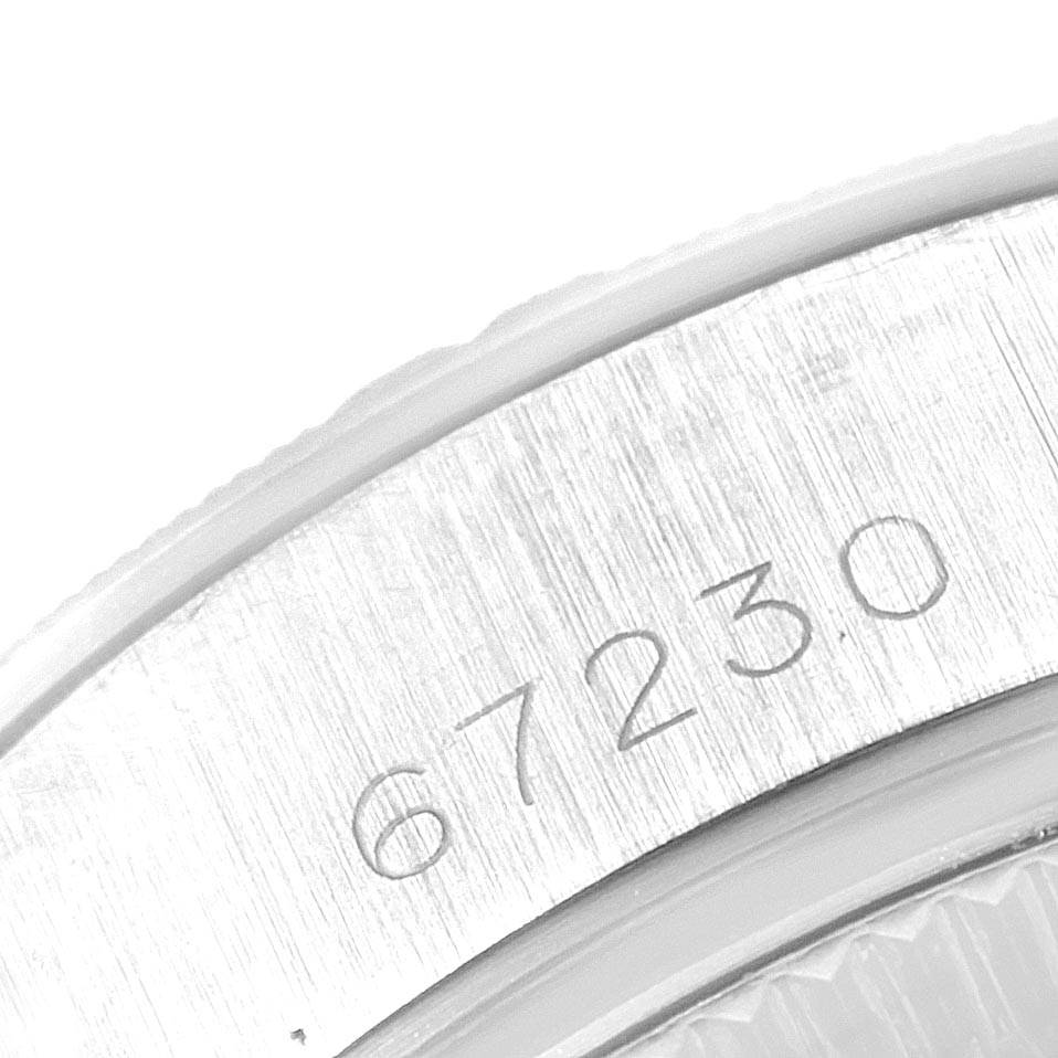Close-up of the serial number engraved on the side bezel of the Rolex Oyster Perpetual 67230 Women
s Stainless Steel Blue Dial 67230 Women
s Stainless Steel Blue Dial watch.