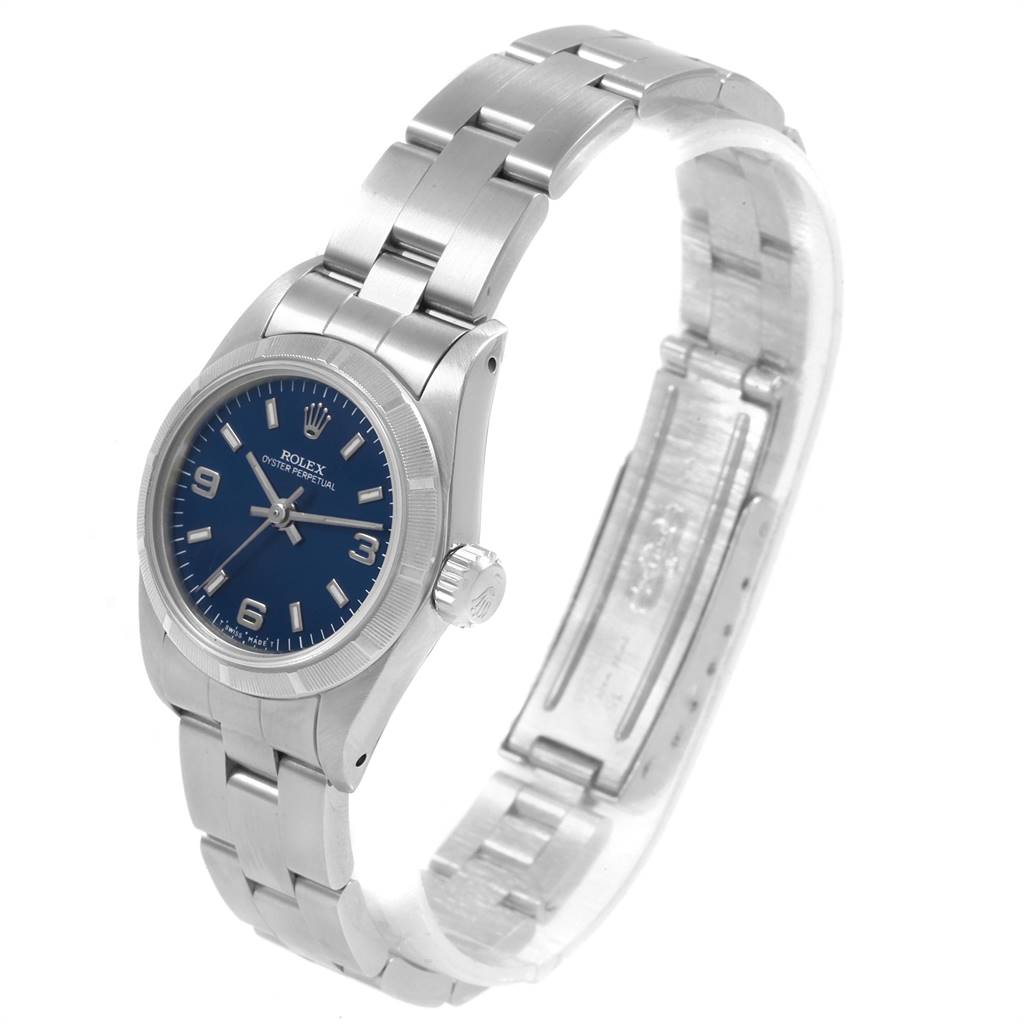 The image shows a side view of a Rolex Oyster Perpetual 67230 Women
s Stainless Steel Blue Dial 67230 Women
s Stainless Steel Blue Dial watch, highlighting the bracelet, crown, and blue dial.