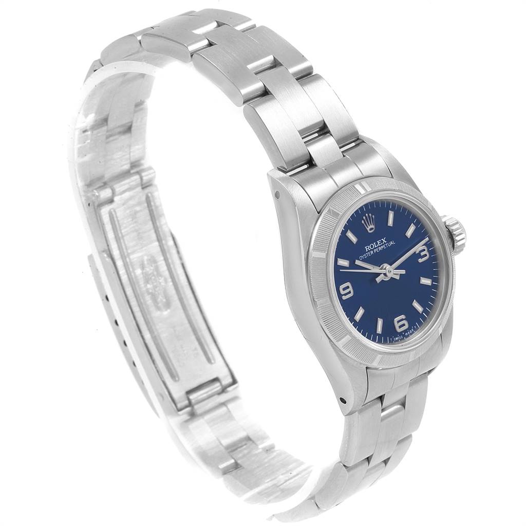 The image shows a Rolex Oyster Perpetual 67230 Women
s Stainless Steel Blue Dial 67230 Women
s Stainless Steel Blue Dial watch from a three-quarter angle, highlighting the face, bezel, and bracelet.