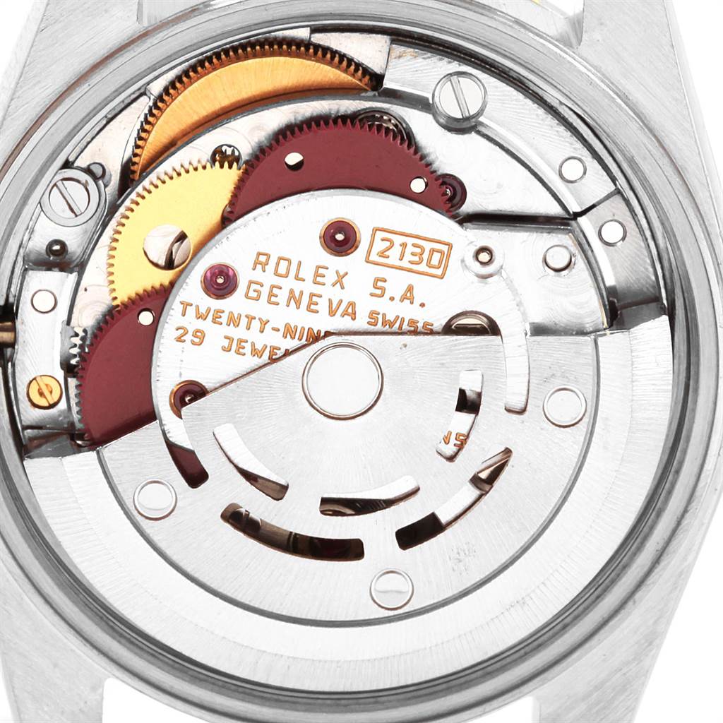 The image shows a close-up view of the movement and internal components of a Rolex Oyster Perpetual 67193 Women
s Steel and Gold (two tone) Black Dial 67193 Women
s Steel and Gold (two tone) Black Dial watch.