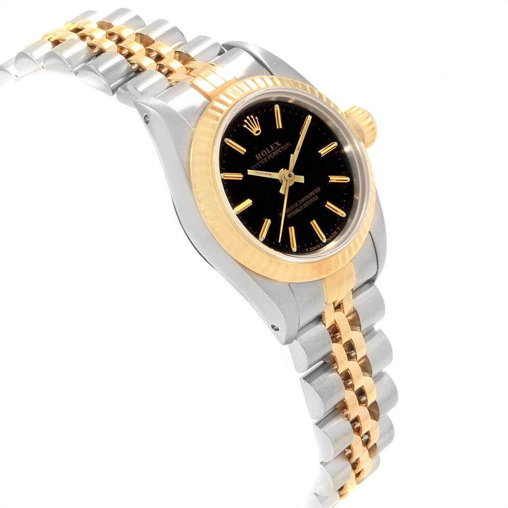 The image shows a Rolex Oyster Perpetual 67193 Women
s Steel and Gold (two tone) Black Dial 67193 Women
s Steel and Gold (two tone) Black Dial watch at a slight angle, highlighting the black dial, gold bezel, and two-tone bracelet.
