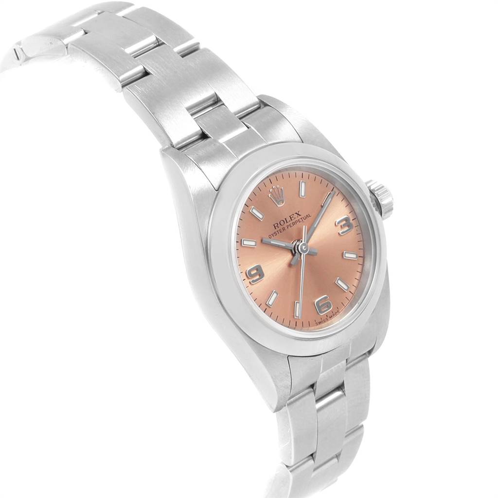 The image shows a Rolex Oyster Perpetual 76080 Women
s Stainless Steel Pink Dial 76080 Women
s Stainless Steel Pink Dial watch at an angled view highlighting its rose-gold dial and stainless steel band.