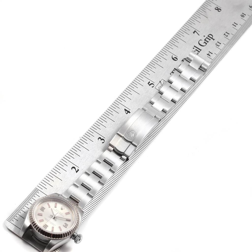 An angled view shows the full bracelet and clasp of the Rolex Oyster Perpetual 176234 Women
s Stainless Steel Silver Dial 176234 Women
s Stainless Steel Silver Dial model, laid next to a ruler for measurement.