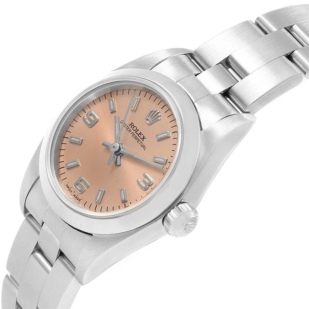 The image shows a side angle of a Rolex Oyster Perpetual 76080 Women
s Stainless Steel Pink Dial 76080 Women
s Stainless Steel Pink Dial watch, highlighting its face, bezel, and part of the bracelet.