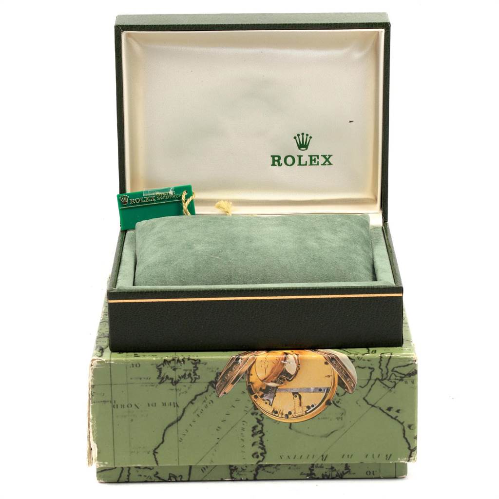 The image shows a Rolex Oyster Perpetual 76080 Women
s Stainless Steel Pink Dial 76080 Women
s Stainless Steel Pink Dial watch box with a green cushion inside and a tag partially visible.