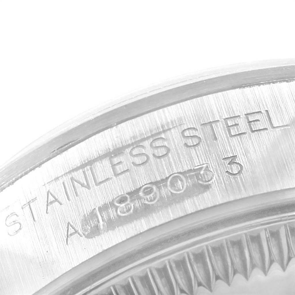 The image shows a close-up of the stainless steel back case with engraved details of a Rolex Oyster Perpetual 76080 Women
s Stainless Steel Pink Dial 76080 Women
s Stainless Steel Pink Dial watch.