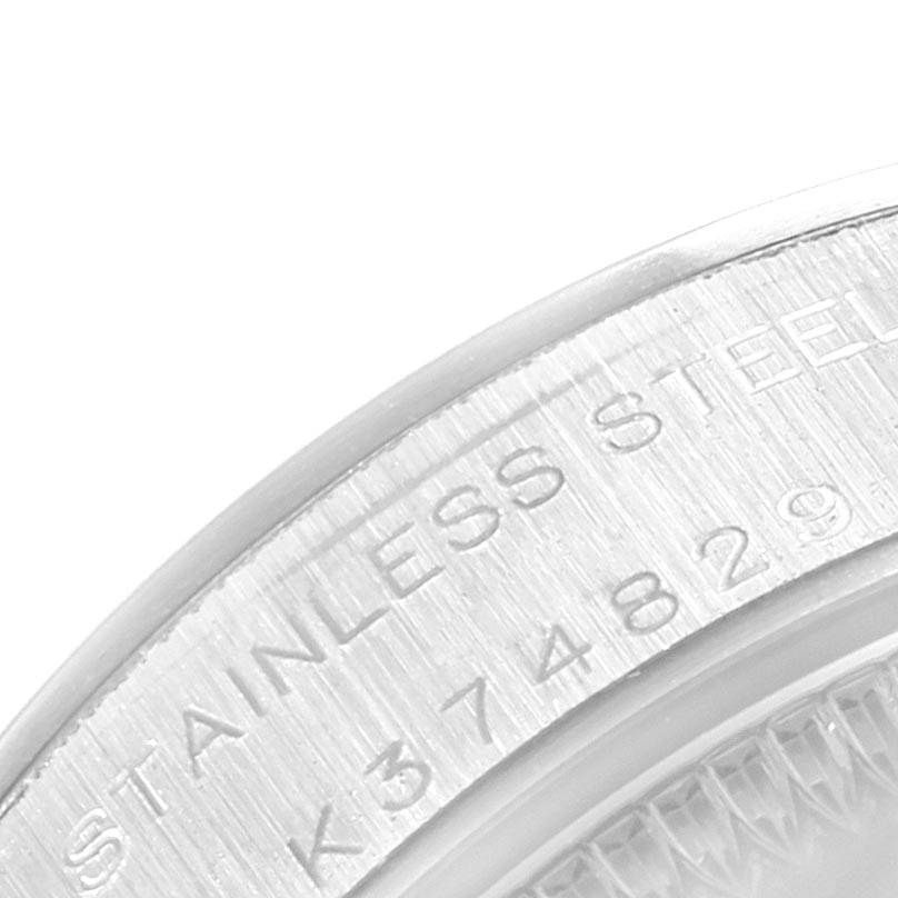 This close-up image shows the case back of a Rolex Oyster Perpetual 76080 Women's Stainless Steel Silver Dial 76080 Women's Stainless Steel Silver Dial watch, highlighting the engraved "STAINLESS STEEL" text and some numbers.